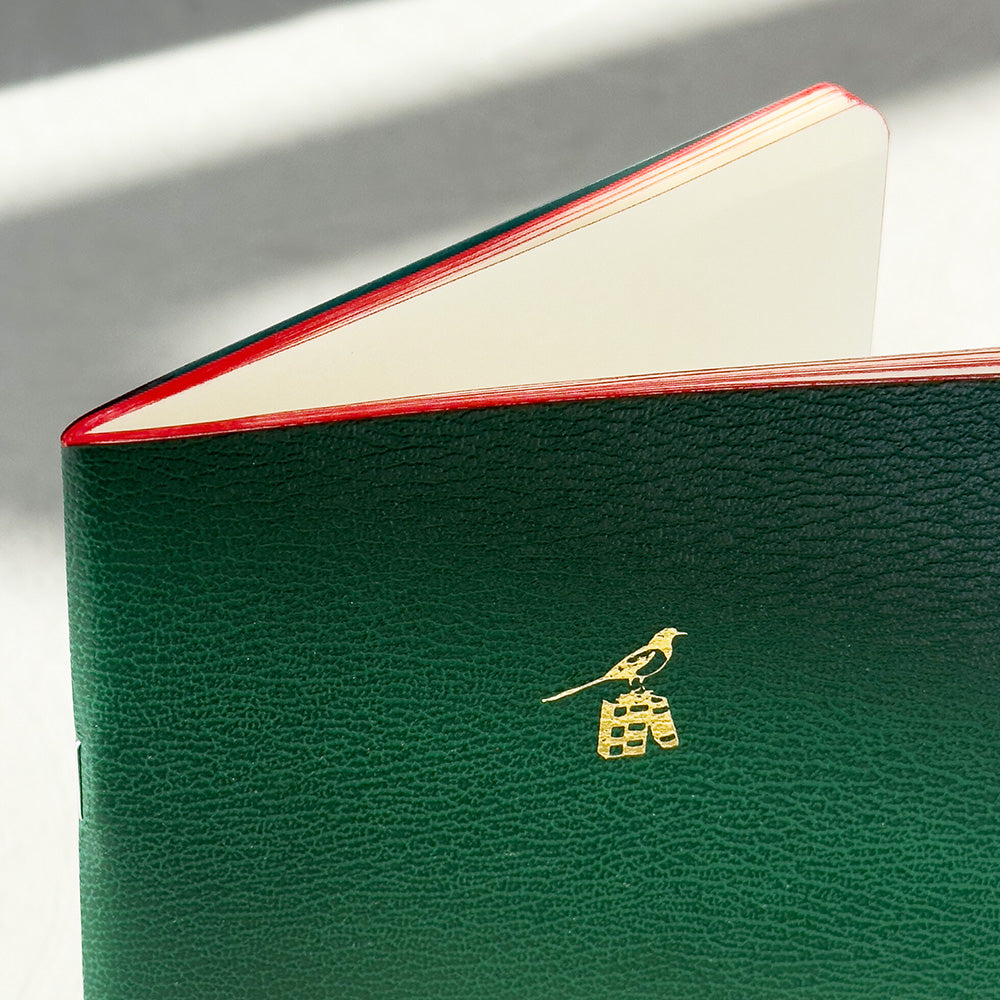 Bieffe Notebook - Small - Green - Made In Italy detail
Green leather wallet with gold emblem on a white background