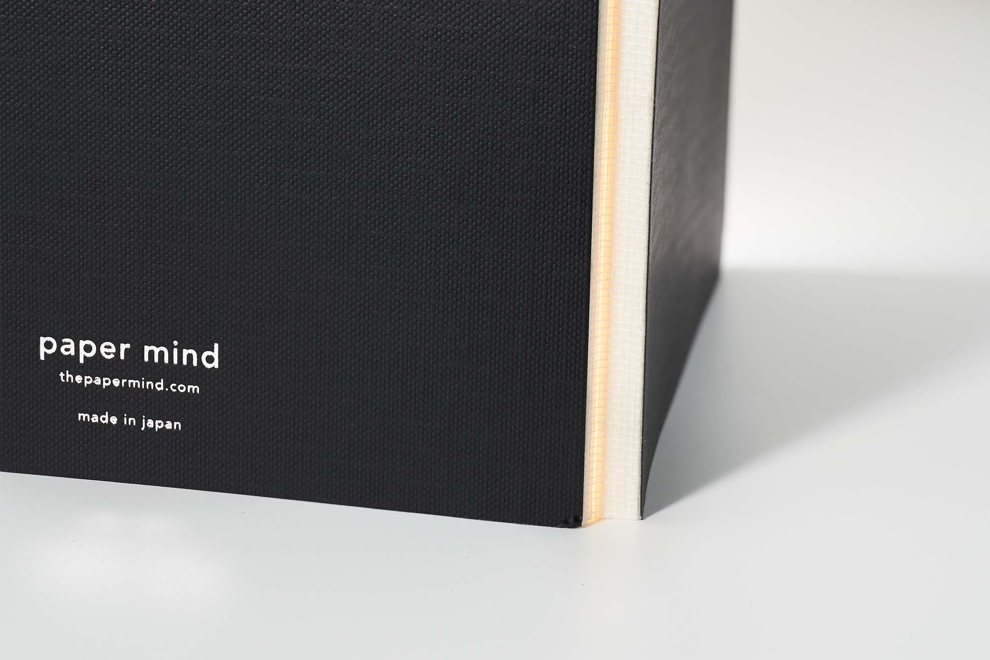 Mitsubishi Bank paper notebook from paper mind standing up on table open and showing spine of notebook