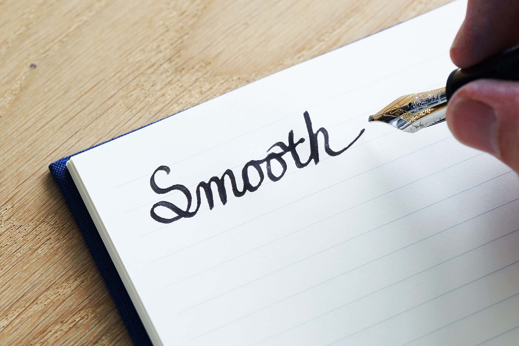 The Paper Mind Passepied Cream Fountain Pen Friendly Notebook Paper open with the word smooth written in black ink with a Montblanc fountain pen
